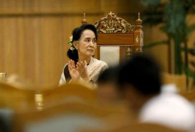 National League for Democracy (NLD) party leader Aung San Suu Kyi applauds as she attends a farewell ceremony at the Parliament in Naypyitaw